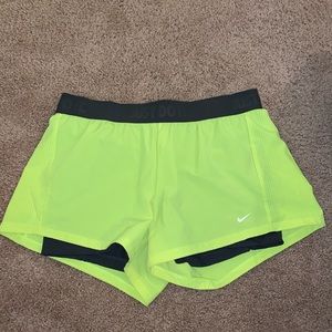 NIKE. Neon yellow workout shorts.